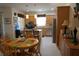 Open kitchen with light wood cabinets, island, and dining area at 25115 Esmeralda Ct, Punta Gorda, FL 33955