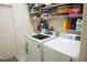 Laundry room with washer, dryer, and ample shelving at 25115 Esmeralda Ct, Punta Gorda, FL 33955