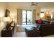 Spacious living room featuring a sectional sofa and sliding glass doors at 25115 Esmeralda Ct, Punta Gorda, FL 33955