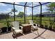 Outdoor patio space featuring two white Adirondack chairs with neutral cushioned seating at 25115 Esmeralda Ct, Punta Gorda, FL 33955