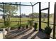 Bright screened-in patio offering tranquil outdoor views and enhanced with potted plants at 25115 Esmeralda Ct, Punta Gorda, FL 33955