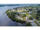 An aerial view showcases the waterfront community with tennis courts, docks, and beautiful coastal scenery at 25228 Nocturne Ln, Punta Gorda, FL 33983