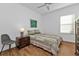 Guest bedroom with a comfortable bed and ceiling fan at 25228 Nocturne Ln, Punta Gorda, FL 33983
