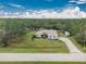 House nestled on a large lot with lush greenery at 27545 Monte Cristo Blvd, Punta Gorda, FL 33955