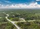 Property view showcasing home's location and surrounding land at 27545 Monte Cristo Blvd, Punta Gorda, FL 33955