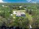 House with a pool and detached shed, surrounded by lush greenery at 27545 Monte Cristo Blvd, Punta Gorda, FL 33955