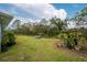 Relaxing backyard oasis with lush landscaping and a peaceful waterfront view at 27545 Monte Cristo Blvd, Punta Gorda, FL 33955