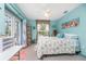 Bedroom with beachy decor, a queen bed, and access to a patio at 27545 Monte Cristo Blvd, Punta Gorda, FL 33955