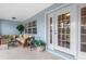 Relaxing covered porch with wicker furniture and potted plants at 27545 Monte Cristo Blvd, Punta Gorda, FL 33955