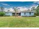 Light blue house with palm trees and a brick walkway at 27545 Monte Cristo Blvd, Punta Gorda, FL 33955
