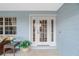 White front door with glass panes, welcoming porch, and potted plants at 27545 Monte Cristo Blvd, Punta Gorda, FL 33955