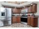 Kitchen boasts stainless steel appliances and wood cabinets at 27545 Monte Cristo Blvd, Punta Gorda, FL 33955