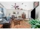Spacious living room with hardwood floors, comfortable furniture, and large TV at 27545 Monte Cristo Blvd, Punta Gorda, FL 33955