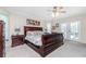 Bright main bedroom with a king-size sleigh bed and French doors at 27545 Monte Cristo Blvd, Punta Gorda, FL 33955