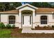 Front door entryway with white door and arched entry at 3488 Froude, North Port, FL 34286