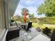 Backyard patio with seating area, orange umbrella, and lush greenery at 3980 Champagne Ave, North Port, FL 34287