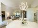 Dining area with white table, chairs, and a stylish chandelier at 3980 Champagne Ave, North Port, FL 34287