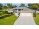 Charming single-story home with attached two-car garage and landscaped front yard at 3980 Champagne Ave, North Port, FL 34287