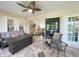 Florida room with wicker furniture, ceiling fan, and view into living room at 3980 Champagne Ave, North Port, FL 34287