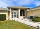 Welcoming front walkway with decorative plants and a cozy sitting area at 3980 Champagne Ave, North Port, FL 34287