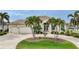 Beautiful two-story home with palm trees and a large driveway at 4025 Maltese Ct, Punta Gorda, FL 33950