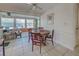 Bright dining area with a round table and four chairs, adjacent to a sunroom at 6245 Freemont St, North Port, FL 34287