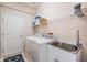 Laundry room with washer, dryer, and utility sink at 10721 Banfield Dr, Riverview, FL 33579