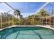 Inviting pool area with screened enclosure and lush landscaping at 1081 Fleetwood Nw Dr, Port Charlotte, FL 33948