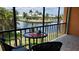 Canal view from screened balcony, table and chairs at 1345 Mediterranean Dr # A203, Punta Gorda, FL 33950