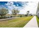 Landscaped backyard with walkway and water views at 17074 Acapulco Rd # 121, Punta Gorda, FL 33955