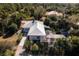 Aerial view of home with metal roof, pool, and lush landscaping at 17221 Elder Ave, Port Charlotte, FL 33954