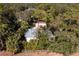 Aerial view of a single story home with metal roof and lush landscaping at 17221 Elder Ave, Port Charlotte, FL 33954