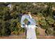 Aerial view of a house with a metal roof, pool, and lush landscaping at 17221 Elder Ave, Port Charlotte, FL 33954