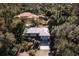 Aerial view of a single-story house in a wooded area at 17221 Elder Ave, Port Charlotte, FL 33954