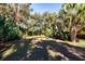 Lush backyard with tropical landscaping and grassy area at 17221 Elder Ave, Port Charlotte, FL 33954