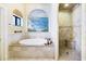 Luxurious bathroom with soaking tub, shower, and decorative wall mural at 17221 Elder Ave, Port Charlotte, FL 33954