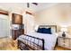 Main bedroom with iron bed frame, wood floors, and ensuite bathroom access at 17221 Elder Ave, Port Charlotte, FL 33954