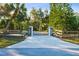 Private gated entrance with a long paved driveway leading to a beautiful home at 17221 Elder Ave, Port Charlotte, FL 33954