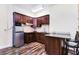 Modern kitchen with stainless steel appliances, wood cabinets, and granite counters at 17221 Elder Ave, Port Charlotte, FL 33954
