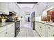 Kitchen with white cabinets, granite counters and tin backsplash at 17221 Elder Ave, Port Charlotte, FL 33954