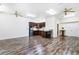 Open kitchen and living area with wood-style flooring and ceiling fans at 17221 Elder Ave, Port Charlotte, FL 33954
