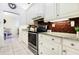 Kitchen with white cabinets, granite counters and tin backsplash at 17221 Elder Ave, Port Charlotte, FL 33954