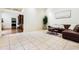 Spacious living room with a leather sectional sofa and tile floors at 17221 Elder Ave, Port Charlotte, FL 33954