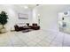 Living room with brown sectional sofa, tiled floor, and neutral walls at 17221 Elder Ave, Port Charlotte, FL 33954
