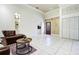 Spacious living room with tiled floors and a comfortable leather sofa at 17221 Elder Ave, Port Charlotte, FL 33954