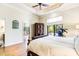 Spacious main bedroom with ceiling fan, wooden floors, an armoire, and pool access at 17221 Elder Ave, Port Charlotte, FL 33954