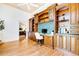 Home office with built-in desk, wooden cabinets, and view to bedroom at 17221 Elder Ave, Port Charlotte, FL 33954