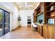 Home office with built-in desk, wood cabinets, and sliding glass door at 17221 Elder Ave, Port Charlotte, FL 33954
