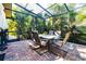 Screened patio with dining set and lush garden views at 17221 Elder Ave, Port Charlotte, FL 33954