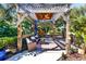 Peaceful pergola with seating area and ceiling fan, perfect for relaxing outdoors at 17221 Elder Ave, Port Charlotte, FL 33954